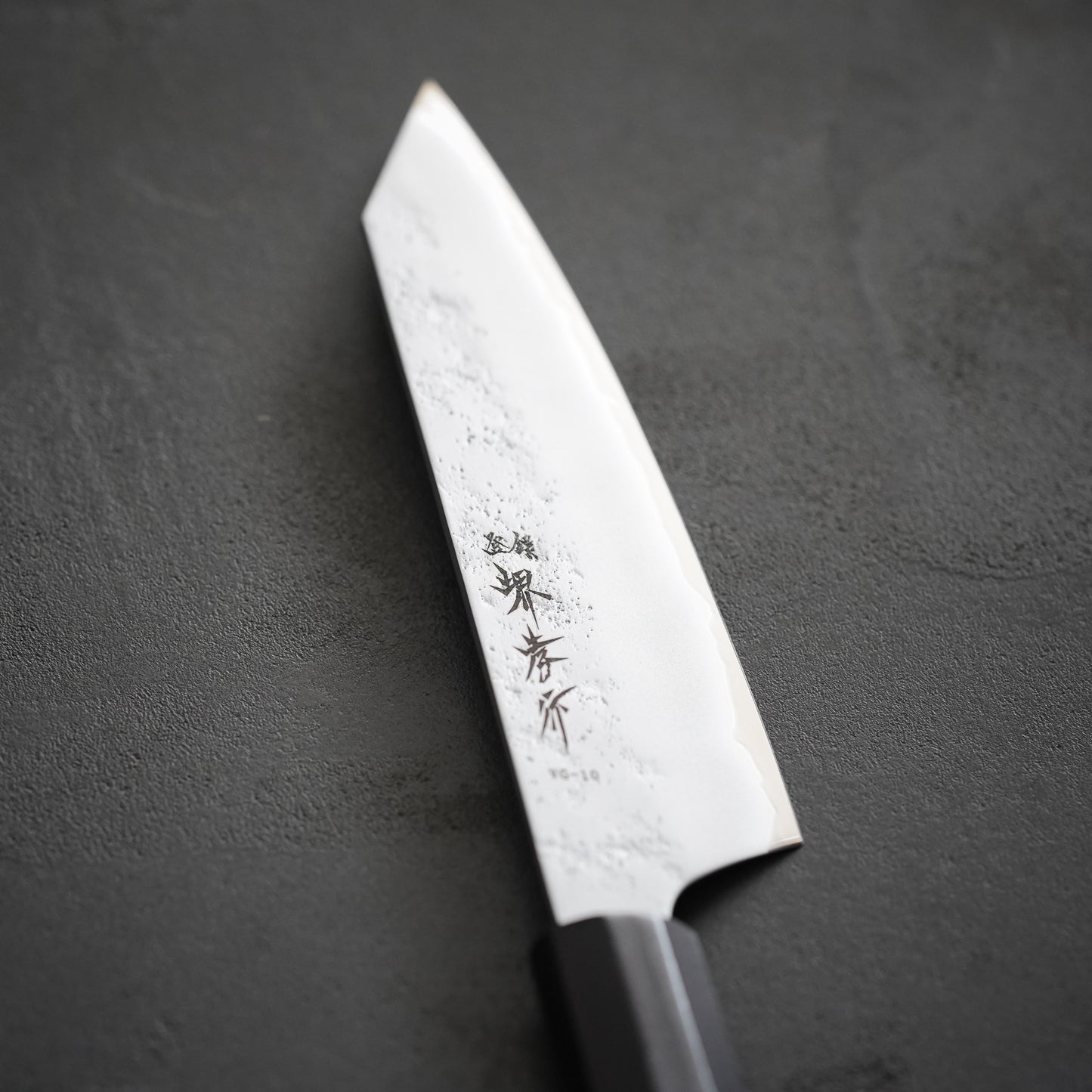 
                  
                    VG10 Nashiji Ebony Handle Sword-Shaped Santoku Knife 160mm / Sakai Takayuki
                  
                